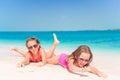 Two little happy girls have a lot of fun at tropical beach playing together Royalty Free Stock Photo