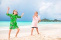 Two little happy girls have a lot of fun at tropical beach playing together Royalty Free Stock Photo