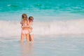 Two little happy girls have a lot of fun at tropical beach playing together Royalty Free Stock Photo