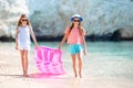 Two little happy girls have a lot of fun at tropical beach playing together Royalty Free Stock Photo