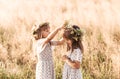 Two little happy identical twin girls playing together in nature in summer. Girls friendship and youth concept. Active children`s