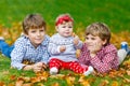 Two little happy kid boys with newborn baby girl, cute sister. Royalty Free Stock Photo