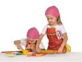 Two little housewifes in colourful aprons Royalty Free Stock Photo