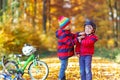 Two little kid boys with bicycles in autumn park Royalty Free Stock Photo