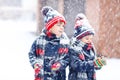 Happy children having fun with snow in winter Royalty Free Stock Photo