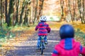 Two little kid boys cycling with bikes in autumn park Royalty Free Stock Photo