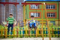 Two little kid boys having fun with swing on outdoor playground. Children, best friends and siblings swinging on warm sunny spring Royalty Free Stock Photo