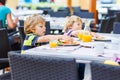 Two little kid boys having healthy breakfast in hotel restaurant Royalty Free Stock Photo