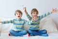 Two little kid boys playing video game at home Royalty Free Stock Photo