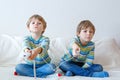 Two little kid boys playing video game at home Royalty Free Stock Photo