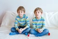 Two little kid boys playing video game at home Royalty Free Stock Photo