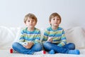 Two little kid boys playing video game at home Royalty Free Stock Photo