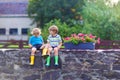 Two little kid boys sitting together on stone bridge Royalty Free Stock Photo