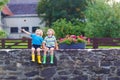 Two little kid boys sitting together on stone bridge Royalty Free Stock Photo