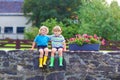Two little kid boys sitting together on stone bridge Royalty Free Stock Photo