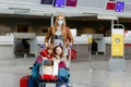 Two little kids, boy and girl and mother in medical mask at airport. Children, family travel by plane during corona Royalty Free Stock Photo