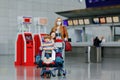 Two little kids, boy and girl and mother in medical mask at airport. Children, family travel by plane during corona Royalty Free Stock Photo