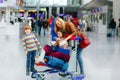 Two little kids, boy and girl, siblings and mother at the airport. Children, family traveling, going on vacation by plane and
