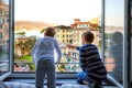 Two little kids boys enjoying view from window in morning on Liguria region in Italy. Awesome villages of Cinque Terre