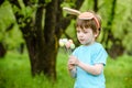 Two little kids boys and friends in Easter bunny ears during traditional egg hunt in spring garden, outdoors. Siblings having fun Royalty Free Stock Photo