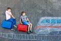 Two little kids boys having fun with train picture drawing with colorful chalks on asphalt. Children having fun with Royalty Free Stock Photo