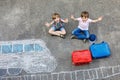 Two little kids boys having fun with train picture drawing with colorful chalks on asphalt. Children having fun with Royalty Free Stock Photo