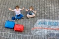 Two little kids boys having fun with train picture drawing with colorful chalks on asphalt. Children having fun with Royalty Free Stock Photo