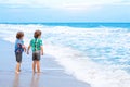 Two little kids boys looking on sunset on the beach of ocean Royalty Free Stock Photo