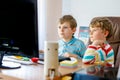 Two little kids boys playing computer games on desktop pc. Modern addict activity for children. Siblings and friends Royalty Free Stock Photo