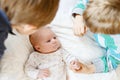 Two little kids boys playing with newborn baby sister girl Royalty Free Stock Photo