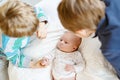 Two little kids boys playing with newborn baby sister girl Royalty Free Stock Photo