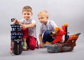 Two little kids boys playing with sailing ship model Royalty Free Stock Photo