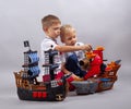 Two little kids boys playing with sailing ship model Royalty Free Stock Photo
