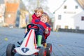 Two little kids boys playing with toy cars, outdoors Royalty Free Stock Photo