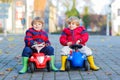 Two little kids boys playing with toy cars, outdoors Royalty Free Stock Photo