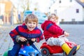 Two little kids boys playing with toy cars, outdoors Royalty Free Stock Photo