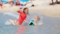 Summer concept with boy and girl playing in water at beach Royalty Free Stock Photo
