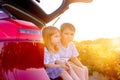 Two little kids peeks out of the car in the sunset.Summer travel Royalty Free Stock Photo