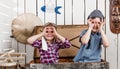 Two little kids in pilot hats making glasses with hands Royalty Free Stock Photo