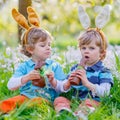 Two little kids playing with Easter chocolate bunny Royalty Free Stock Photo