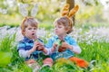 Two little kids playing with Easter chocolate bunny Royalty Free Stock Photo