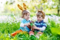 Two little kids playing with Easter chocolate Royalty Free Stock Photo