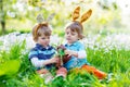 Two little kids playing with Easter chocolate Royalty Free Stock Photo