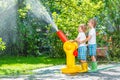 Two little kids playing with garden hose and water Royalty Free Stock Photo