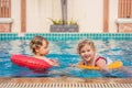 Two little kids playing in the swimming pool Royalty Free Stock Photo