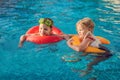 Two little kids playing in the swimming pool Royalty Free Stock Photo