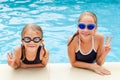 Two little kids playing in the swimming pool Royalty Free Stock Photo