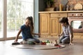 Two little kids playing with toys on warm floor Royalty Free Stock Photo
