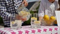 Two little kids are selling lemonade at a homemade lemonade stand on a sunny day with a price sign for an entrepreneur Royalty Free Stock Photo