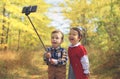 two little kids taking selfie in the park